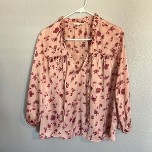 Vici satin like top . Pink background with mauve and purple flowers.